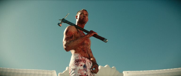 man covered in blood holding a sledge hammer